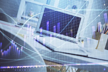 Fototapeta na wymiar Stock market chart hologram drawn on personal computer background. Multi exposure. Concept of investment.