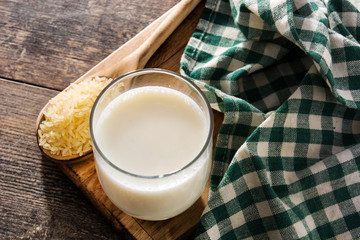Rice milk in glass on wooden table. 