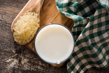 Rice milk in glass on wooden table. Top view