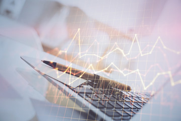 Forex market graph hologram and personal computer on background. Multi exposure. Concept of investment.