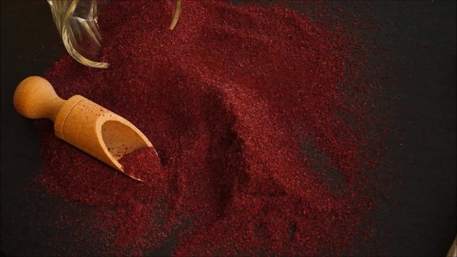 Sumac aromatic spice, sprinkle on the table (delicious food supplement) menu concept. food background. copy space. Top view