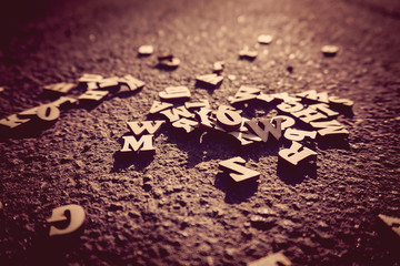 Letters fall on the asphalt, tinted photo of the English alphabe