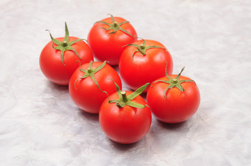 Red tomatoes on a marble background
