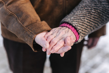 Close up hands of seniors people. Male and female. Couple. Grandpa and grandma. Love forever