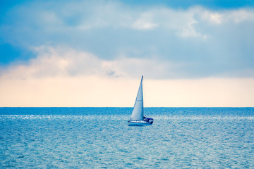 Sailing yacht in the blue calm sea.