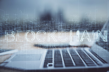 Multi exposure of blockchain theme hologram and table with computer background. Concept of bitcoin crypto currency.