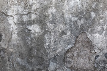Concrete wall with slices, stains and cracks