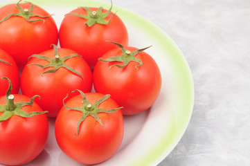 Red tomatoes on a marble background