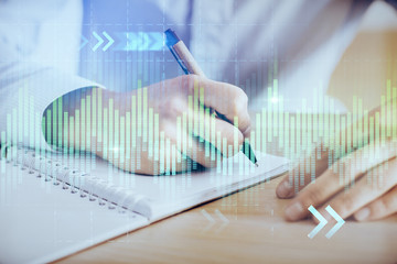 Multi exposure of man planing investment with stock market forex chart.