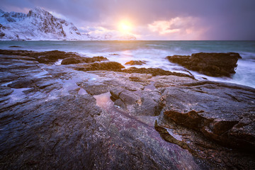 Obraz premium Coast of Norwegian sea on rocky coast in fjord on sunset