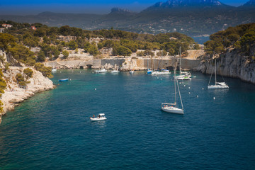 Sailboats moored in a bay of the rocky coast, Calanque de Port Pin, Provence, France, Europe