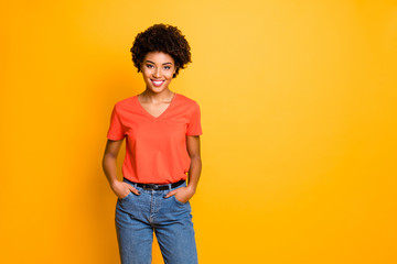 Copyspace photo of cheerful charming cute nice pretty sweet lovely girlfriend afro american holding hands in pockets wearing denim smiling toothily isolated with bright color background