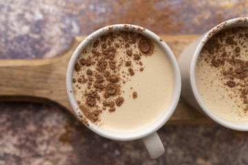 Top view cup of coffee with cocoa powder
