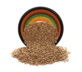 Spelt grains in colorful clay pot, bowl isolated on white background