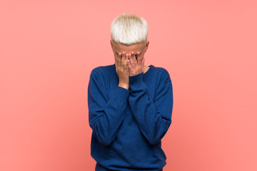 Teenager girl with white short hair over pink wall with tired and sick expression