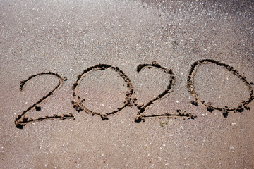2020 written in beach sand
