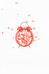 Valentine Day concept with alarm clock and hearts