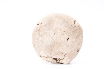 A picture of a single stone in the shape of a natural sphere on a white area.