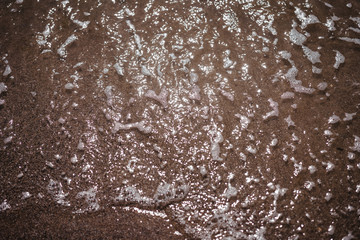 sea ​​water washes sand on the shore, top view