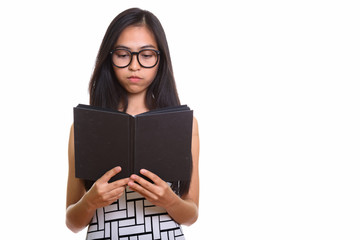 Young Asian teenage nerd girl reading book