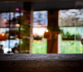 Blurred cafe restaurant club background with wooden table. Place under the text. Empty place. Interer cafe.