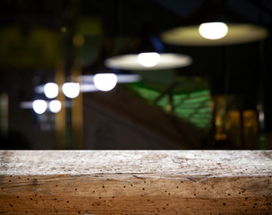 Blurred cafe restaurant club background with wooden table. Place under the text. Empty place. Interer cafe.