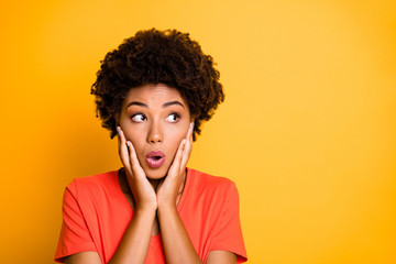 Photo of black afro american fearful girlfriend feeling guilty about something holding her cheeks with hands lips pouted isolated over yellow vibrant color background