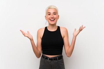 Teenager girl with short hair over white wall with shocked facial expression