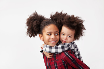 Teenage girl giving her little sister a piggyback ride