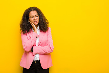 black business woman holding cheek and suffering painful toothache, feeling ill, miserable and...