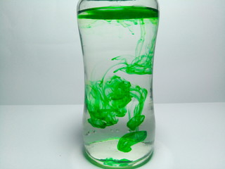 glass of water with ice and mint on white background