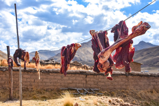 Alpaca meat and bones hang to dry on a washing line in rural Cusco, Peru