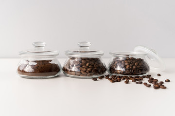 Small containers filled with coffee beans