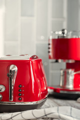 Kitchen shelf with red utensils and dishware