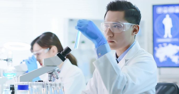 Asian scientist take test tube