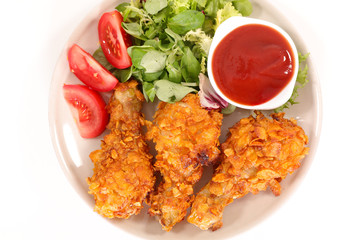 crispy chicken leg with salad and ketchup