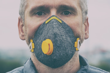 Man wearing a real anti-pollution, anti-smog and viruses face mask