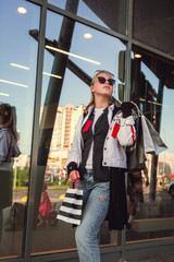 Obraz na płótnie Canvas Woman in shopping. Happy woman with shopping bags enjoying in shopping. Consumerism, shopping, lifestyle concept