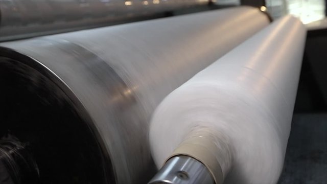 Pliester manufacturing process. Roll-up of non-woven fabric in a factory