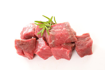 raw beef chop and rosemary on white background