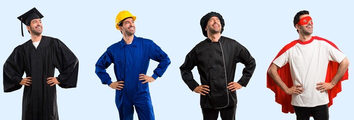 Group of chef, student, worker and super hero posing with arms at hip and laughing