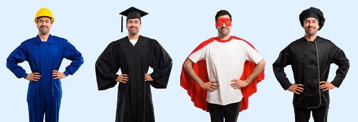 Group of chef, student, worker and super hero posing with arms at hip and laughing looking to the...