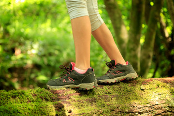 detail girl walking on trunk with green moss 