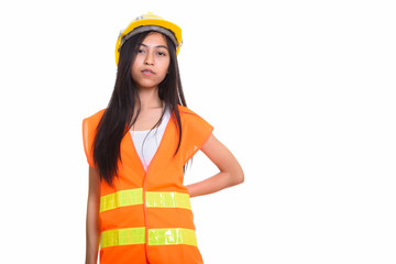Studio shot of young Asian woman construction worker