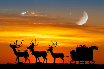 Santa sleigh with reindeer at sunset