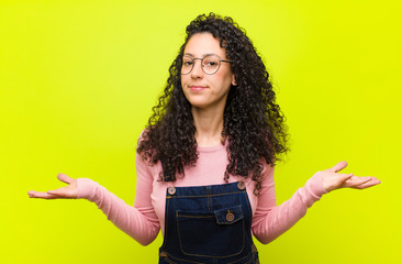 young pretty woman feeling puzzled and confused, unsure about the correct answer or decision,...