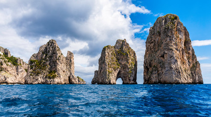 Fototapeta na wymiar Faraglioni - 3 towering rocks off the coast of the Italian island of Capri