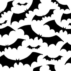 Halloween pattern. Black silhouettes of bats on a white background. Seamless vector backdrop