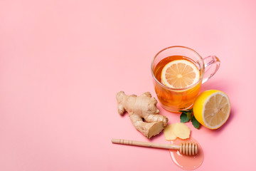 Tea with lemon, ginger and honey on a pink background. Treatment of colds and flu.
