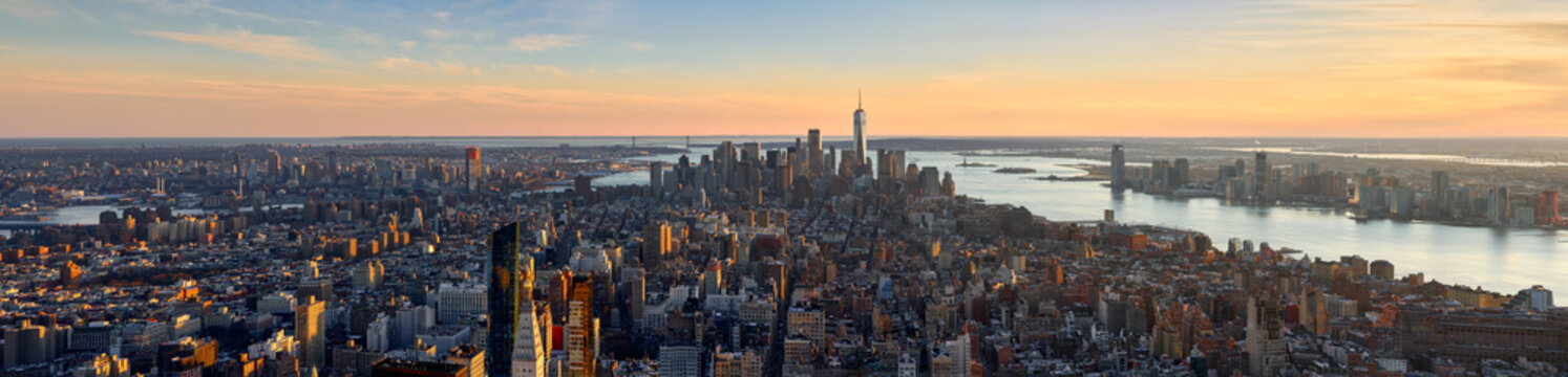 Aerial panoramic view of New York City at Sunset . Brooklyn (left), Midtown and Lower Manhattan (center) with Jersey City (right). USA